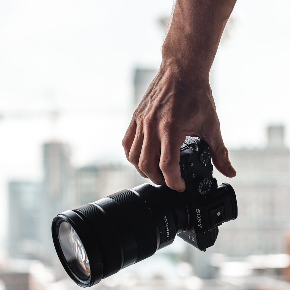 person holding black dslr camera